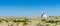 Old dilapidated and abandoned white wooden house on the remote prairie in the middlew of nowhere under a blue sky