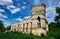 Old dilapidated castle on a background of blue sky with clouds.