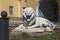 Old dilapidated sculpture of a reclining lion