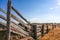 Old dilapidated wooden cattle race fence in the country.