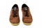 Old dirty brown leather shoes on an isolated white background. Concept, second hand, hard work, walking, worn out pair