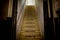 Old dirty damaged abandoned wooden stairs to the garret. Entrance to the attic.