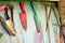 Old dirty farm gardening tools, spade, fork and rake on wooden wall