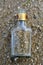 Old dirty glass bottle on a sandy beach