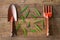 Old dirty grunge rusty gardening tools with green leaves on dirty grunge wooden background