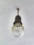 Old dirty light bulb in socket on ceiling, close up