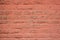 Old dirty red pink brick wall with mildew stains. rough surface texture