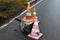 Old dirty traffic cones on the wet asphalt at the edge of the road