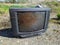 old and dirty tube tv outdoors close up photo