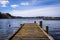 Old dirty wooden pier or jetty for yachts and boats. Spring landscape of the coast of Sweden.