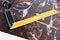 Old dirty yellow carpenter ruler on a carpentry workbench