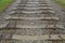 Old dismantled railway with grass on the side of the road