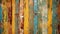 old and distressed cracked painted fence panels in vibrant yellows and blues