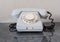 Old disused landline telephone set of gray color close-up with shadow