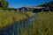 Old disused wooden bridge crossing a small canal