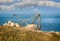 Old disused wooden crane used to move Portland stone against coastal background taken in Portland, Dorset, UK