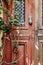 Old door with antique brass knocker in the shape of a hand