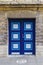 Old door in bright blue colors in very old building.