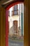 Old door in colonial architecture deteriorated by time seen through another door