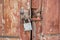 The old door locked with a padlock hanging brackets