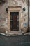 An old door in a typical empty Italian street, Lecce, Italy