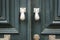 Old doorknocker with hand shape on old wooden door