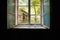 Old double-glazed window in the darkness of the room of an abandoned building