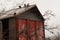 Old dovecote in autumn cloudy garden, rural building