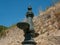 Old drinking fountain and rustic stone wall in Porto, Portugal. Close up.