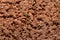 Old dry red crushed bricks surface on outdoor tennis ground. Detail of texture