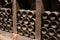 Old dusty bottles of red rioja wine in cellars, wine making in La Rioja region, Spain