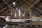 Old and dusty creepy wooden attic with roof framework structure of the old house Awesome horror attic