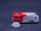 Old dusty fire truck toy car with coins lying at the front wheel - coins are Czech