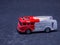 Old dusty fire truck toy car on gray background