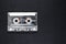 Old and Dusty Music Cassette on Black Background Surface with free Space