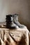 Old dusty vintage boots standing on canvas