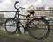 Old dutch bike chained against a bridge