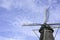 Old Dutch windmill from the year 1776 with blue cloudy sky and flying birds, Zwolle, The Netherlands