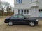 Old elegant black Japanese sedan car Nissan Almera 1.6 parked