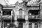 An old elegant dilapidated mansion. Restoration and repair. Front view. Black and white photo