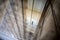 The old elevator shaft with ropes viewed through a metal cage creating a bokeh effect