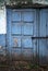 Old embossed wooden door painted in blue