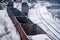 Old emergency wagons rust under the snow. Empty freight cars are at the train station. View from above. Industrial Transport