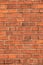 Old empty brick house factory wall with red bricks