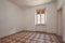 Old, empty room interior with tiled, decorated floor