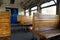 Old empty wagon of train. Wooden seats in an empty coach of train