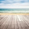 Old empty wooden pier perspective on sandy beach