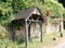 Old English wooden bus stop with a horseshoe