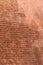 Old eroding brick wall texture background with red bricks and eroding stucco