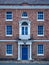 Old European brick facade with windows and columns in a symmetric